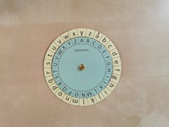 A paper wheel with different symbols sits on a desk. 