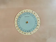 A paper wheel with different symbols sits on a desk.