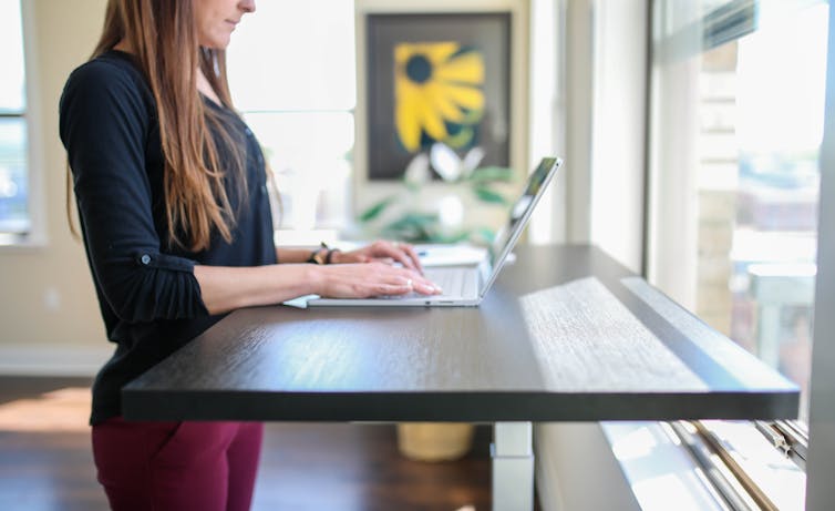 woman stands at desk