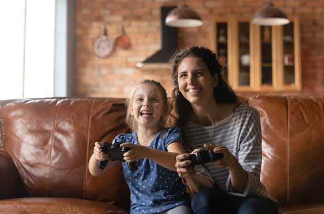 A child and a mother with game consols