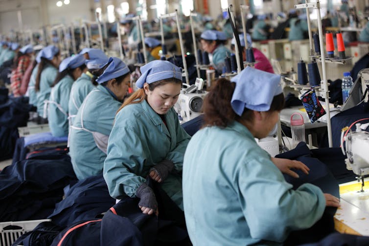 Garment workers sew clothes at a factory in Huaibei, Anhui province, China.