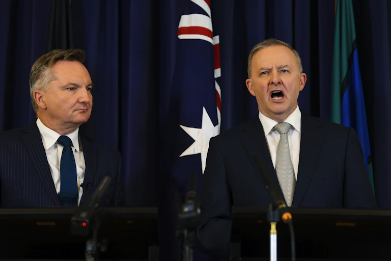 two men stand at lecterns