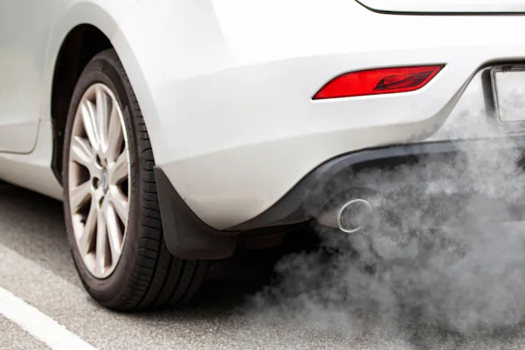 Car exhaust pipe with fumes coming out.