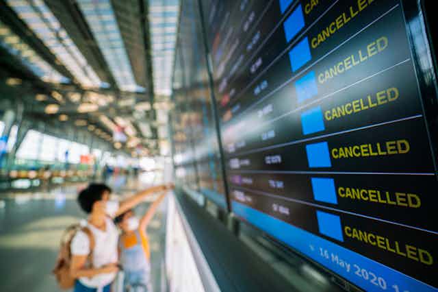 Airport departures board with rows of cancelled flights