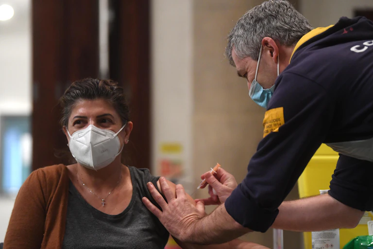 A woman receiving a COVID vaccine