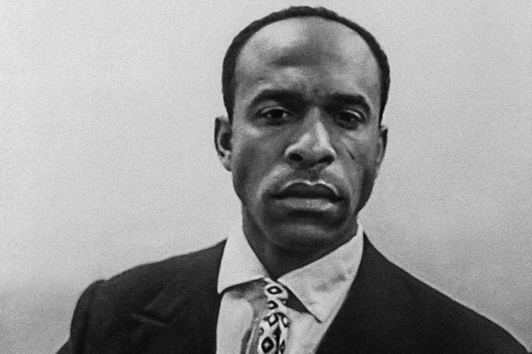 A man wearing a shirt, tie and jacket strikes a serious pose in this head and shoulders photo