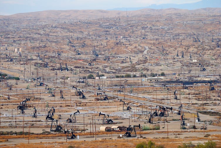 A California oil field dotted with derricks.