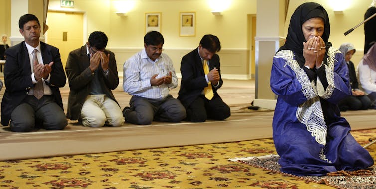 Muslim woman leading a Friday prayer.