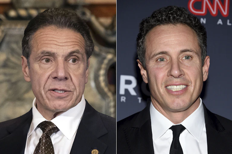Two men in side by side photos; both in white shirts, blazers and who look like brothers because they are.