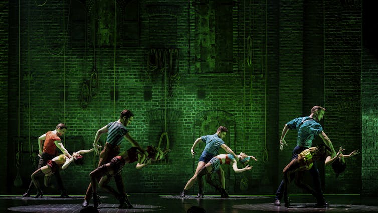 Production image: four pairs dance a tango