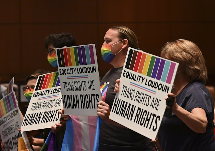 People hold placards.