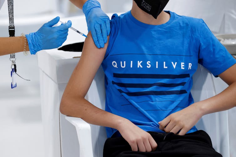 A teenager receiving a COVID vaccine.
