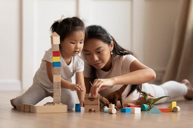 Mum and daughter playing with blocks.