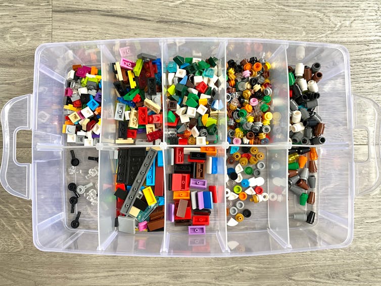 box of Lego blocks organised into compartments.