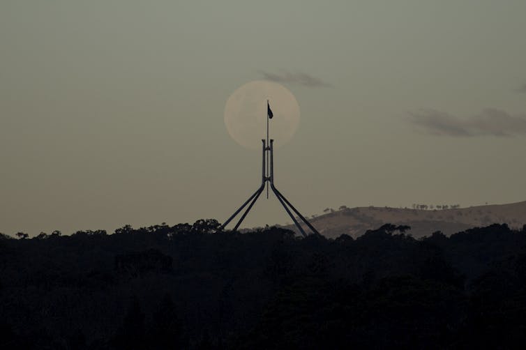 Moon rising over Parliament House.