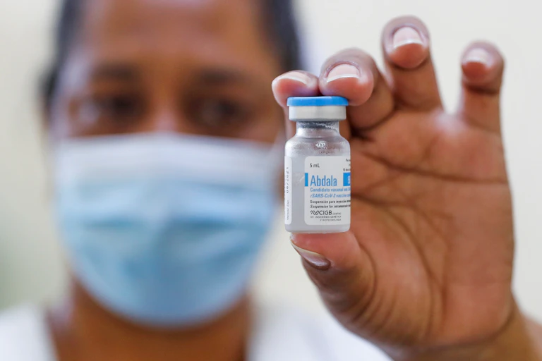 A nurse holding up a vial of Cuba's Abdala COVID vaccine