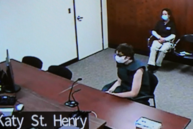 Ethan Crumbley sits on a chair in a courtroom.