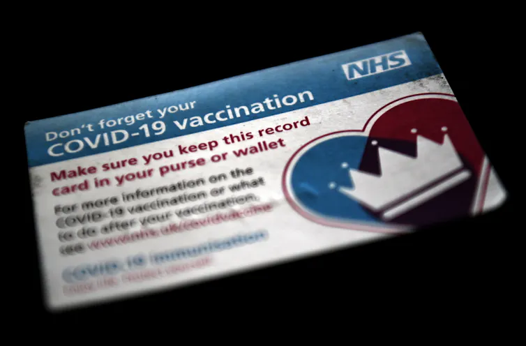 vaccination card on dark surface