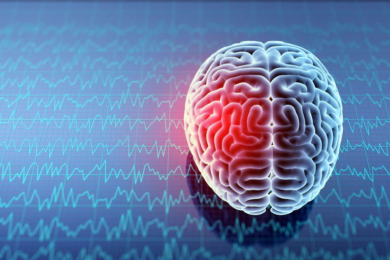 Illustration of brain with one area glowing red against a backdrop of brainwave readouts.