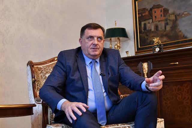 Bosnian Serb leader Milorad Dodik gestures while seated.