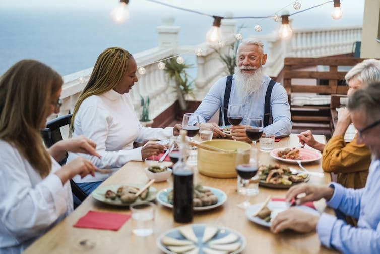 People eating together at a table outdoors