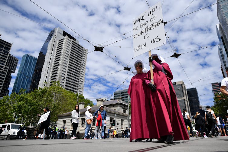 Protesters against mandatory vaccinations and other Victorian government measures in Melbourne on November 20 2021. Frustration with the 'asleep' majority is common among those who believe COVID-19 and vaccines are part of a larger sinister agenda.