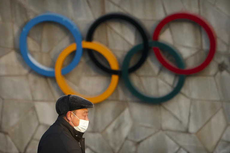 Man in front of Olympic rings