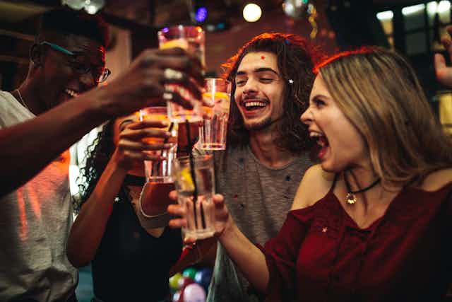 Young people drinking alcohol in a bar