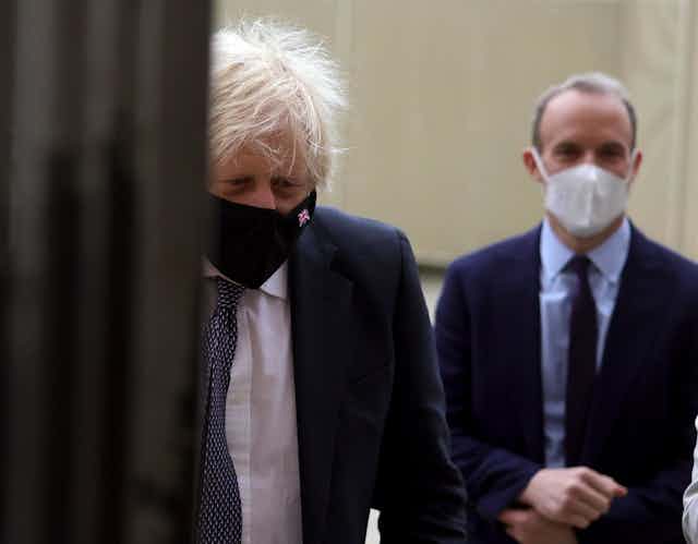 Prime Minister Boris Johnson and Justice Minister Dominic Raab wearing COVID facemaks.