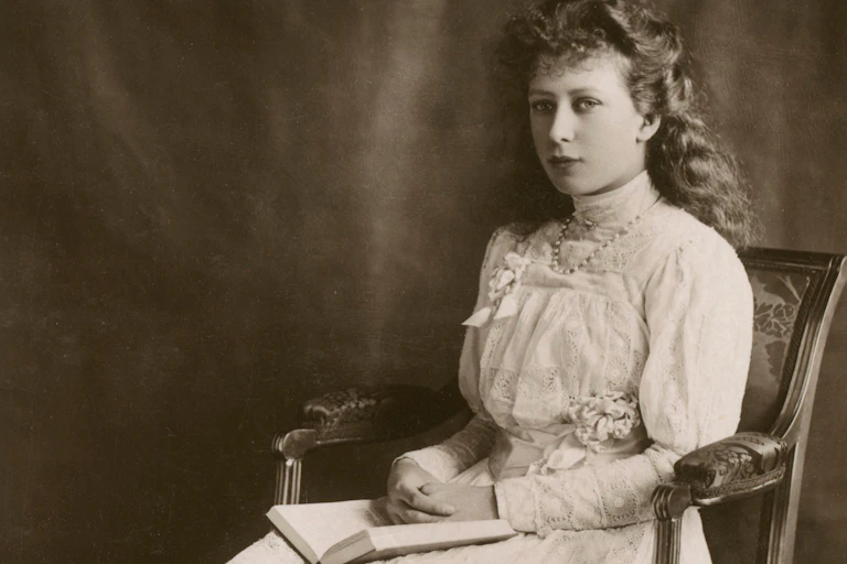 Old image of young girl in a chair