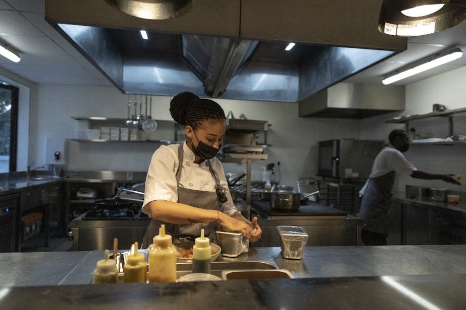 A chef prepares food in a professional kitchen.