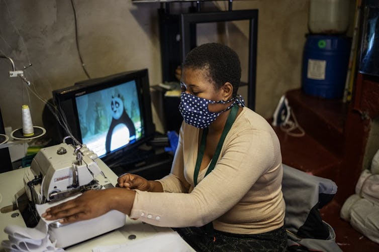 A woman uses a sewing machine