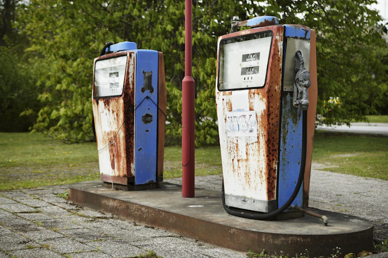 Two old rust gas pumps.