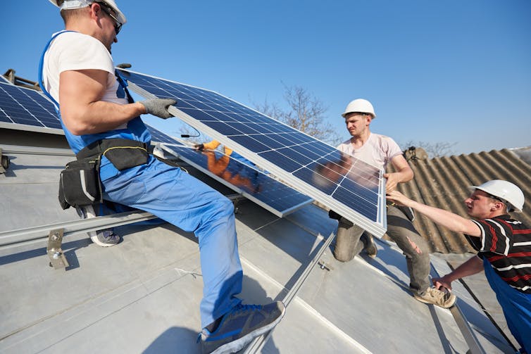 Solar technicians installing panels