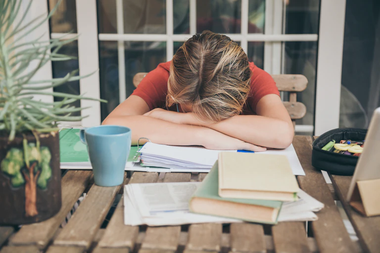 Woman asleep at her desk at home