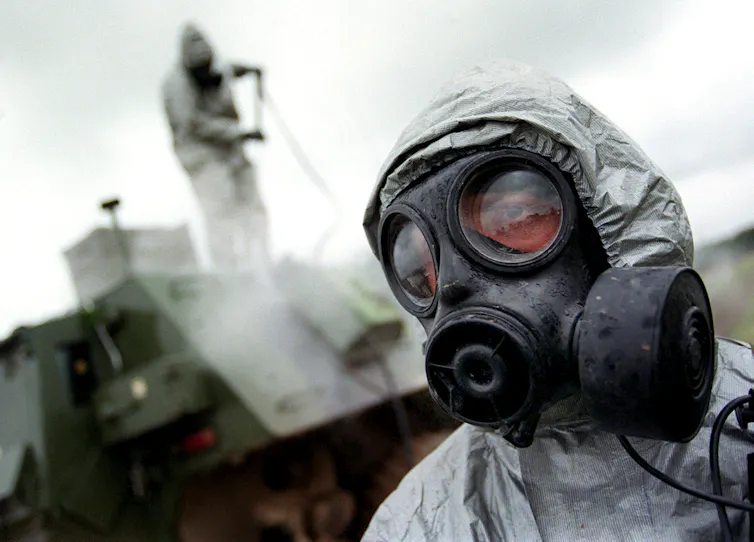 Soldiers wearing gas masks