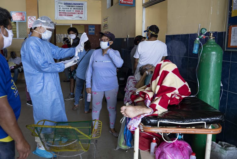 A COVID patient being assessed in a regional hospital ward in Iquitos, Peru