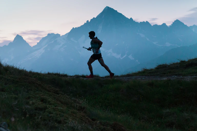 Man runs on mountain range.
