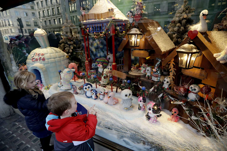 Children look at a toys in a Christmas window display