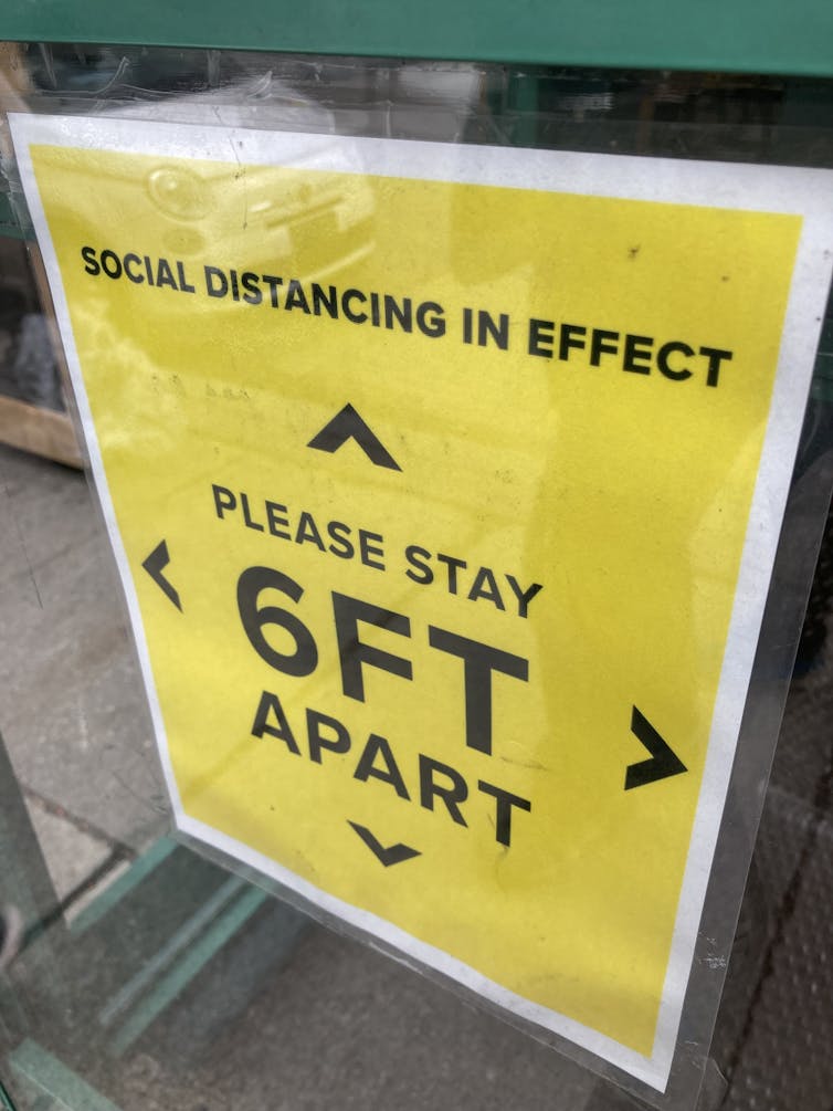 Sign says stay six feet apart.