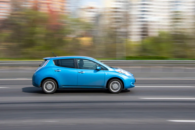 Nissan Leaf moving down a blurry road