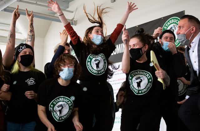 Starbucks employees and supporters react as votes are read during a viewing of their union election.