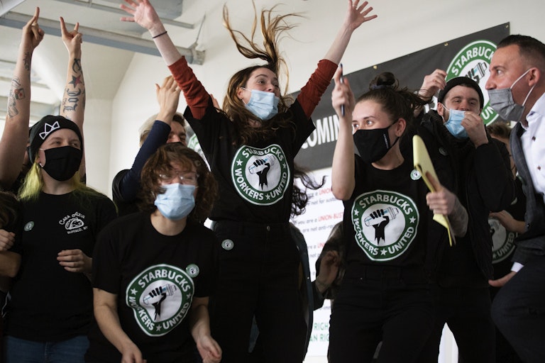 Starbucks employees and supporters react as votes are read during a viewing of their union election.