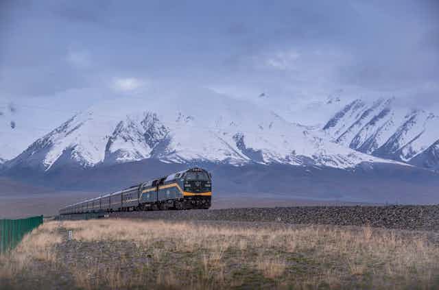 Train with snowy mountains in background
