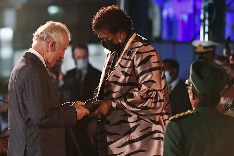 Barbados President Dame Sandra Mason gives Prince Charles the nation's Order of Freedom.