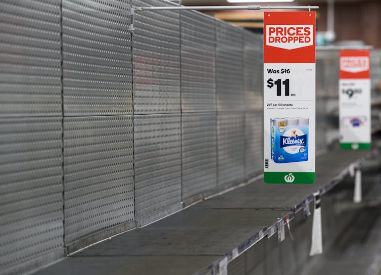 Empty shelves normally filled with rolls of toilet paper at a Woolworths supermarket in Sydney on Friday, March 13, 2020.