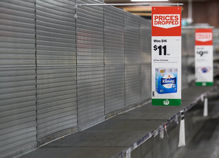 Empty shelves normally stocked with toilet paper rolls at a Woolworths supermarket in Sydney, Friday, March 13 2020.