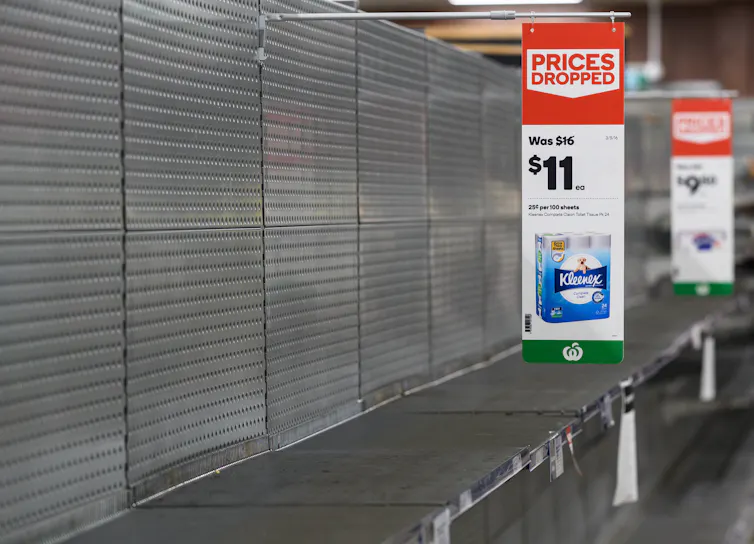 Empty shelves normally stocked with toilet paper rolls at a Woolworths supermarket in Sydney, Friday, March 13 2020.