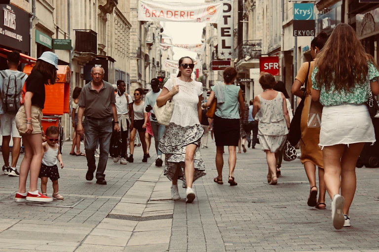 Woman walks on a busy street.