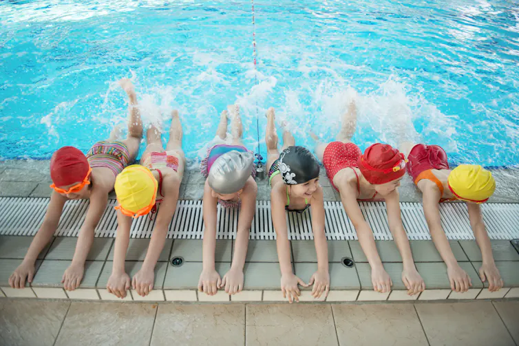 Children kick in a pool.